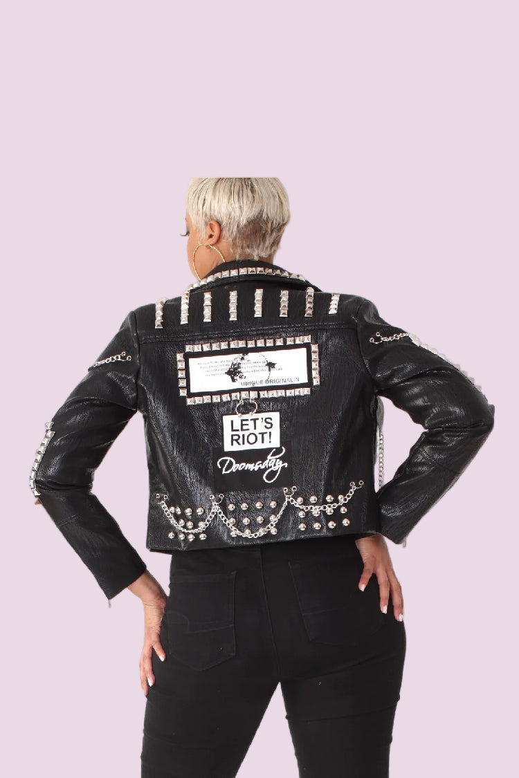 Black studded leather moto jacket showing back view with bold graphic print and stud accents, For Her NYC