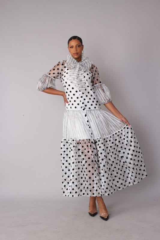 Model wearing Victorian polka dot tiered maxi dress in white and black, front view holding skirt, For Her NYC