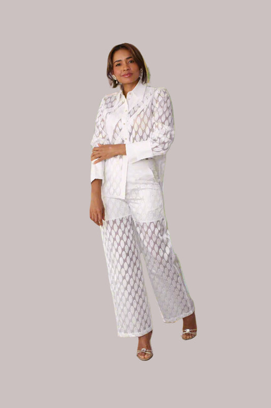 Eyelet wide-leg pants style 82339 in white shown from the front in a standing pose highlighting the eyelet fabric and relaxed wide-leg silhouette by For Her NYC