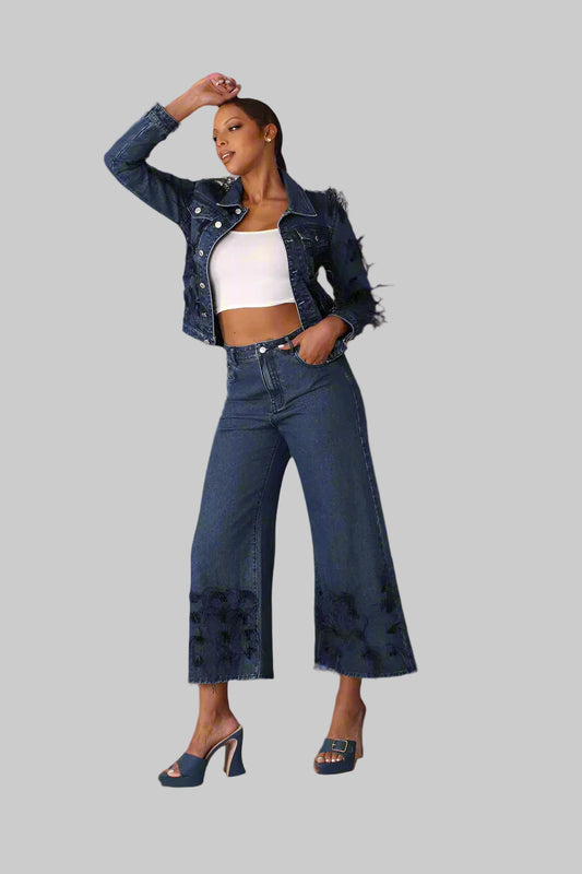 Blue denim jacket with black feather trim shown front standing pose styled with matching denim pants, For Her NYC