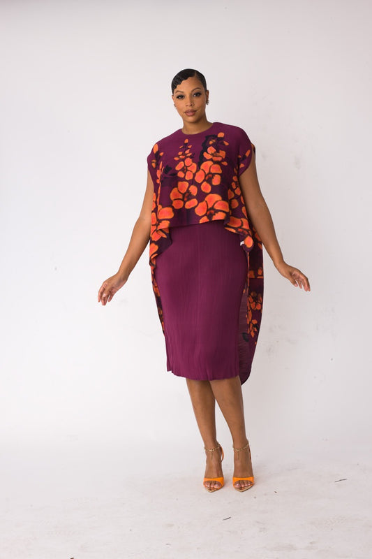 Model wearing the red and purple floral overlay shift dress walking forward, showcasing asymmetrical draped overlay and modern silhouette by For Her NYC