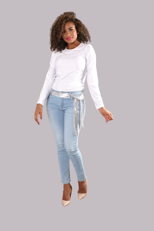 Model wearing white long sleeve basic layering top paired with light-wash jeans by For Her NYC.