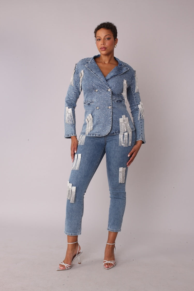 Model wearing the metallic-fringe-cropped-denim jacket-front-standing 82463 with matching jeans 82531 standing front facing, showcasing lustrous finish and dramatic tiered silhouette by For Her NYC