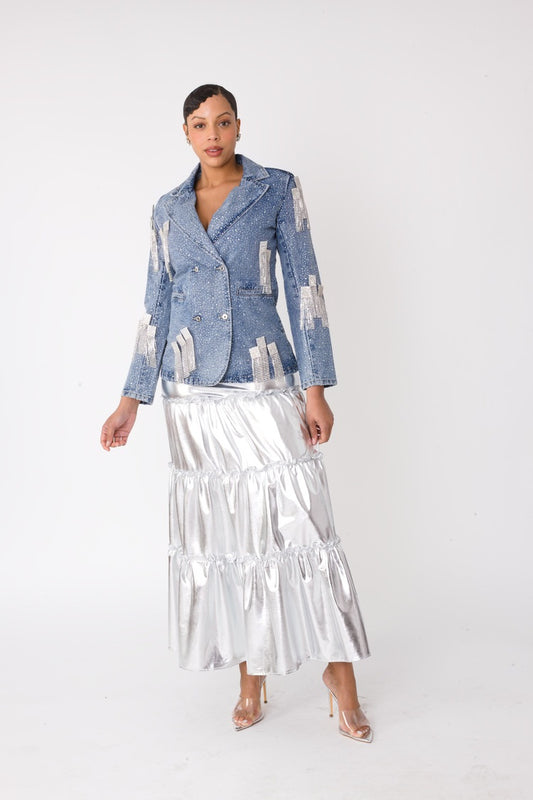 Model wearing the fringe-cropped-denim_jacket with silver metallic tiered maxi skirt standing front facing, showcasing lustrous finish and dramatic tiered silhouette by For Her NYC