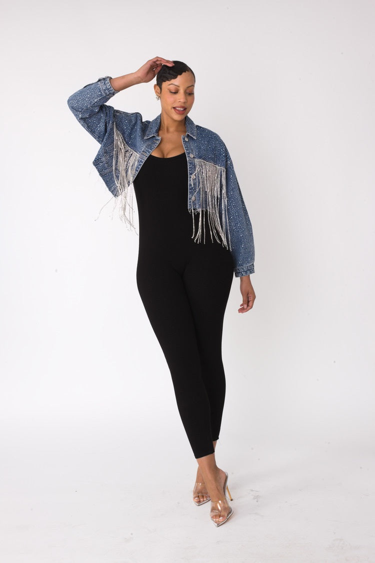 Rhinestone and chain fringe cropped denim jacket shown front view with model hand on head pose, dramatic fringe movement, For Her NYC