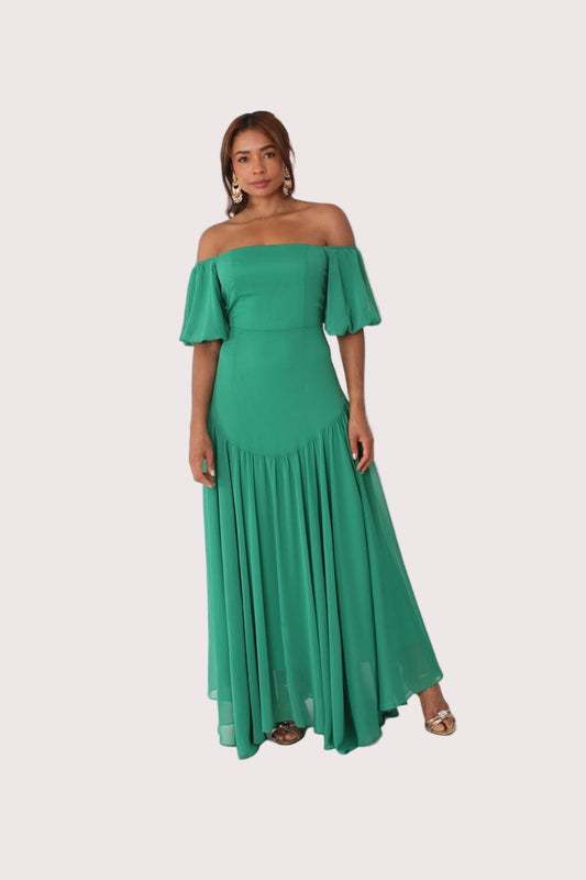 Emerald off-shoulder maxi dress shown front standing view, flowing silhouette and ruffle detail, For Her NYC