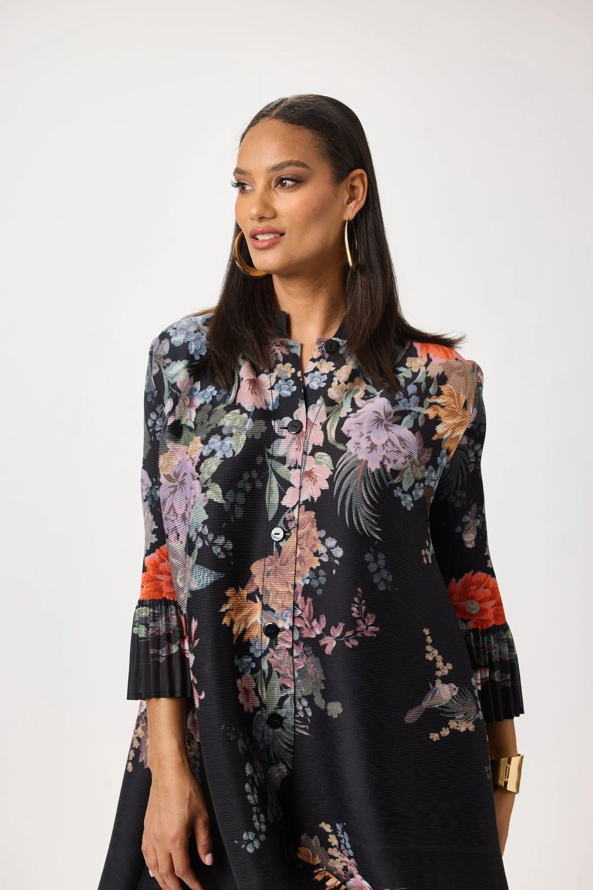 Close-up of the Tally Taylor Spring Garden Print Tunic Pant Set showing the black multicolor floral print, button front and pleated sleeve detail, style S0105.