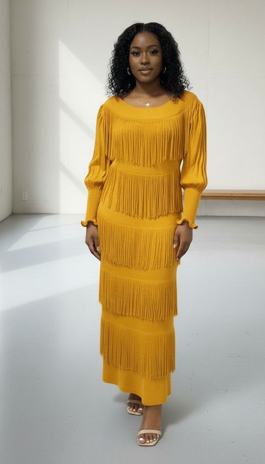 Front view of model wearing yellow tiered fringe knit midi dress with long sleeves and layered fringe detail, For Her NYC
