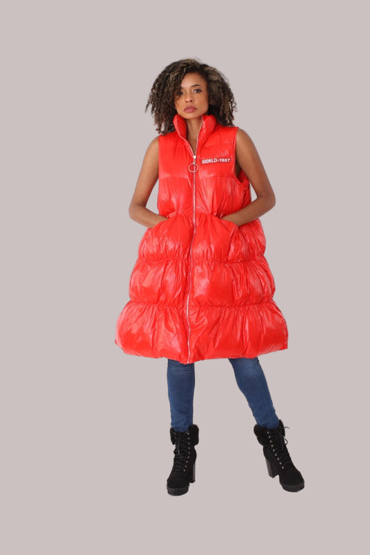 Front view of red tiered puffer vest with high collar and shiny finish — For Her NYC.