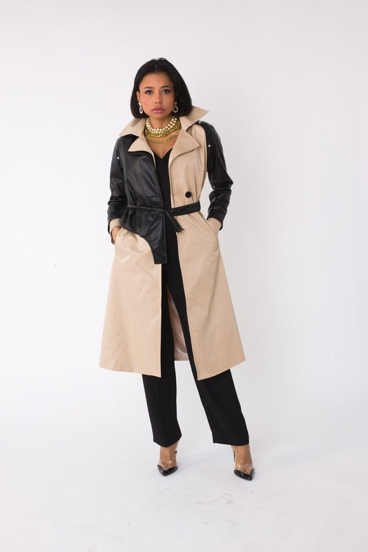 Model wearing the khaki and black two tone leather sleeve trench coat standing front facing, showcasing belted waist and mixed material design by For Her NYC