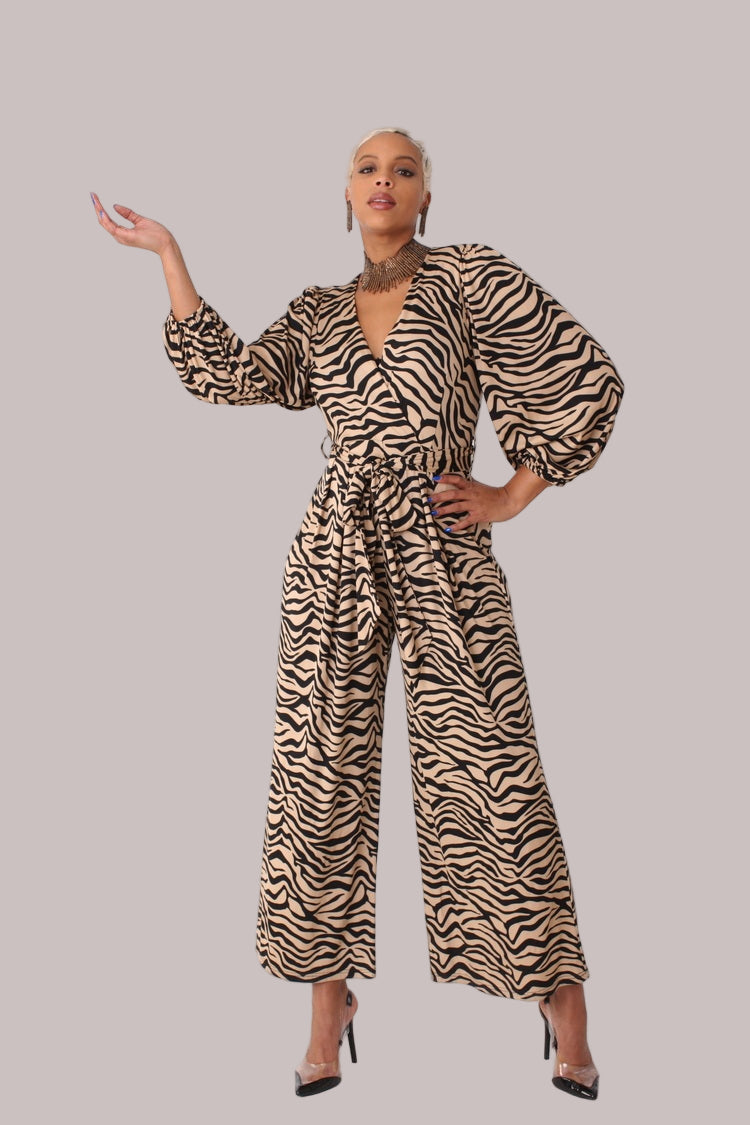 Model with arm raised wearing coffee and black wide-leg jumpsuit with puff sleeves by For Her NYC