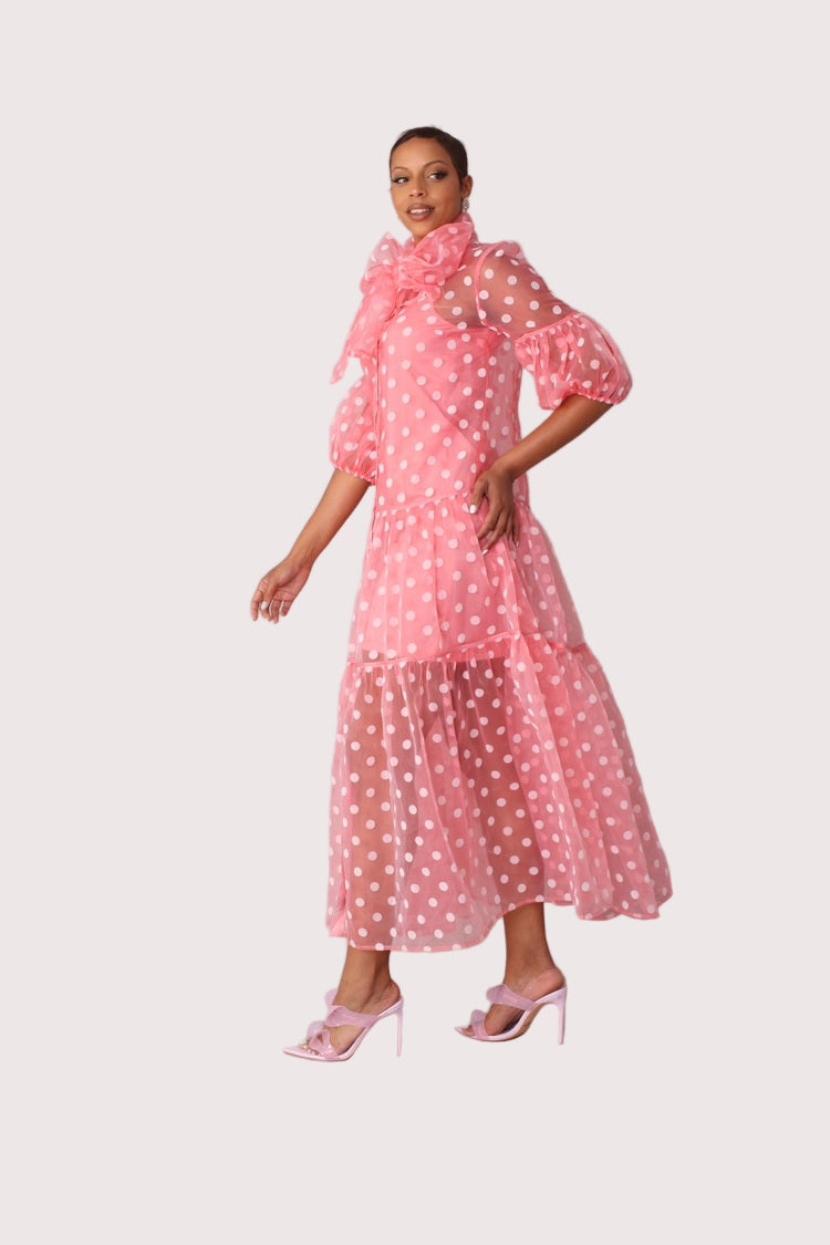Polka dot organza maxi dress style 82234 in coral and white shown in a three-quarter standing pose emphasizing the airy silhouette and polka dot texture by For Her NYC