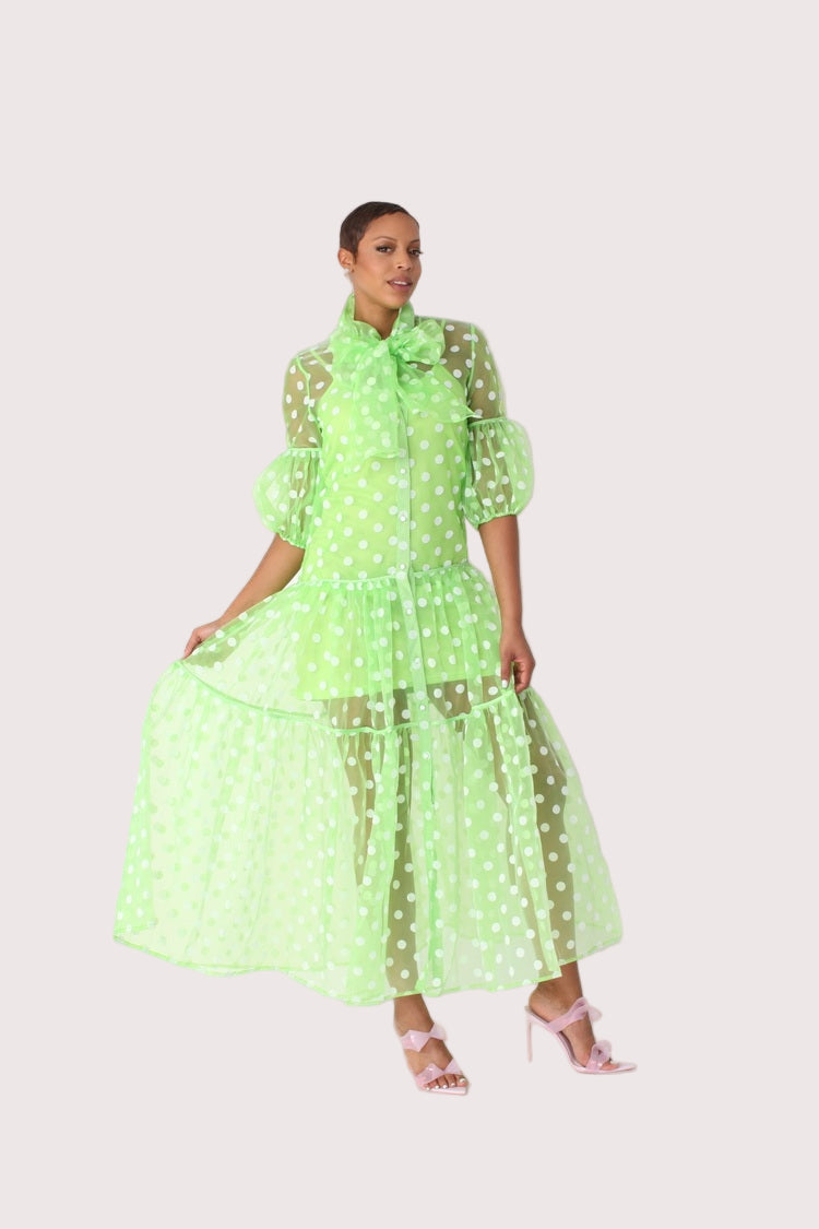 Polka dot organza maxi dress style 82234 in yellow and white shown in a walking forward pose emphasizing movement and airy organza layers by For Her NYC