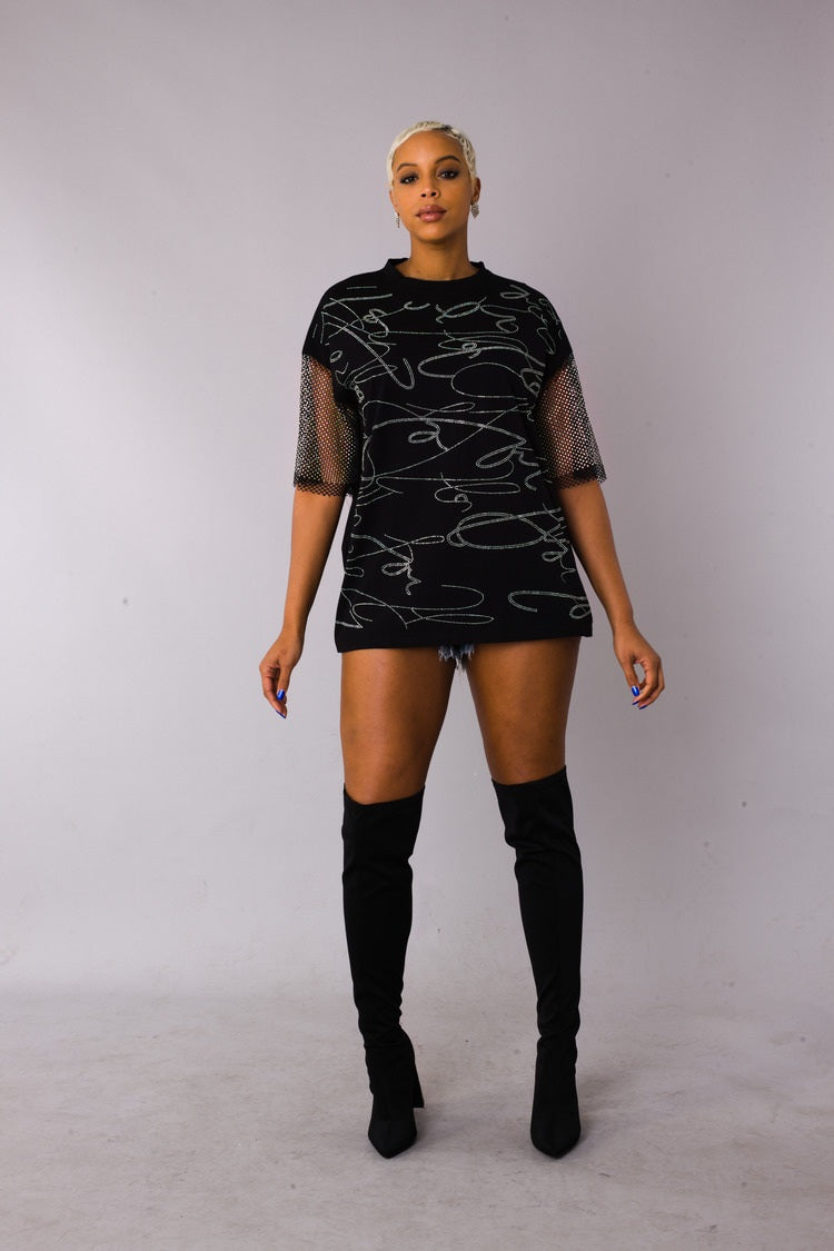 Rhinestone script mesh sleeve top style 82235 in black shown front-facing in a standing pose highlighting the rhinestone script detail and mesh sleeves by For Her NYC