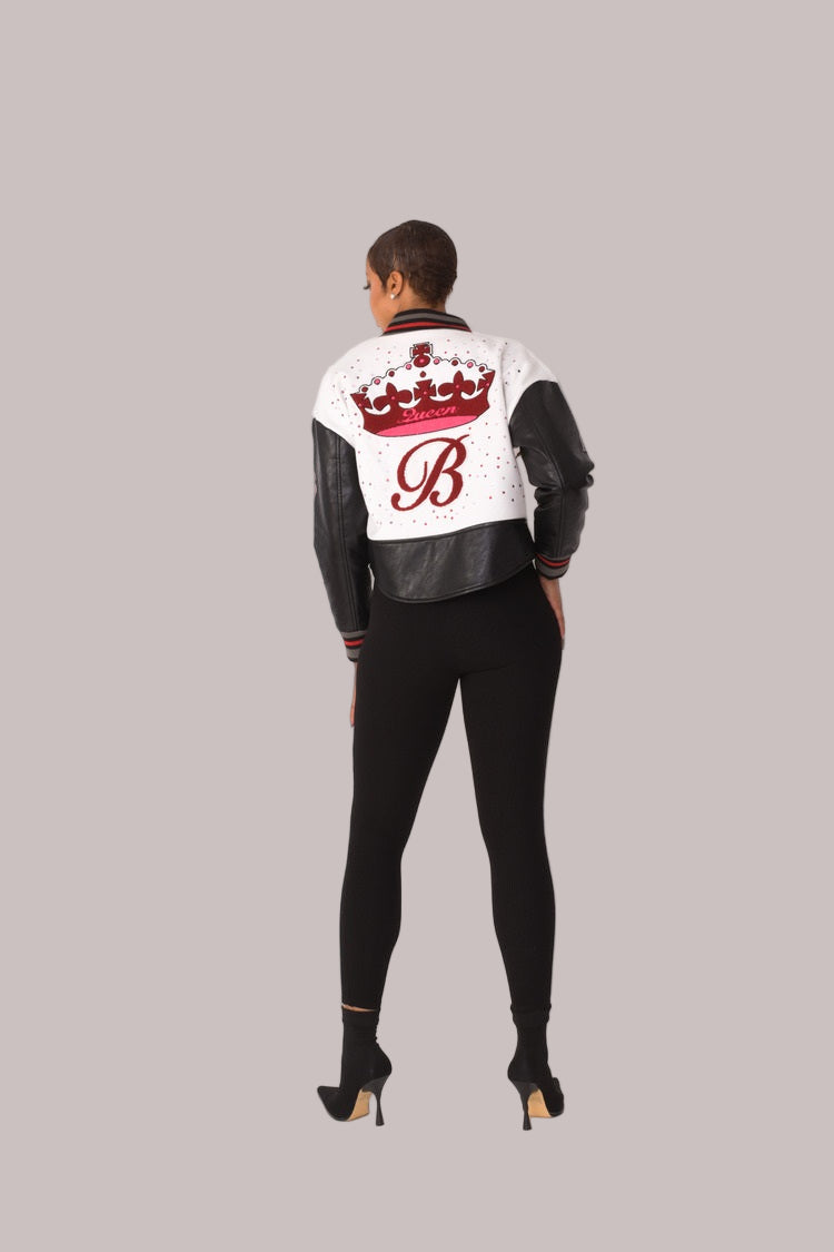 Betty Boop varsity crop jacket style 82236 in white and black shown from the back in a standing pose highlighting the graphic back detail and cropped length by For Her NYC