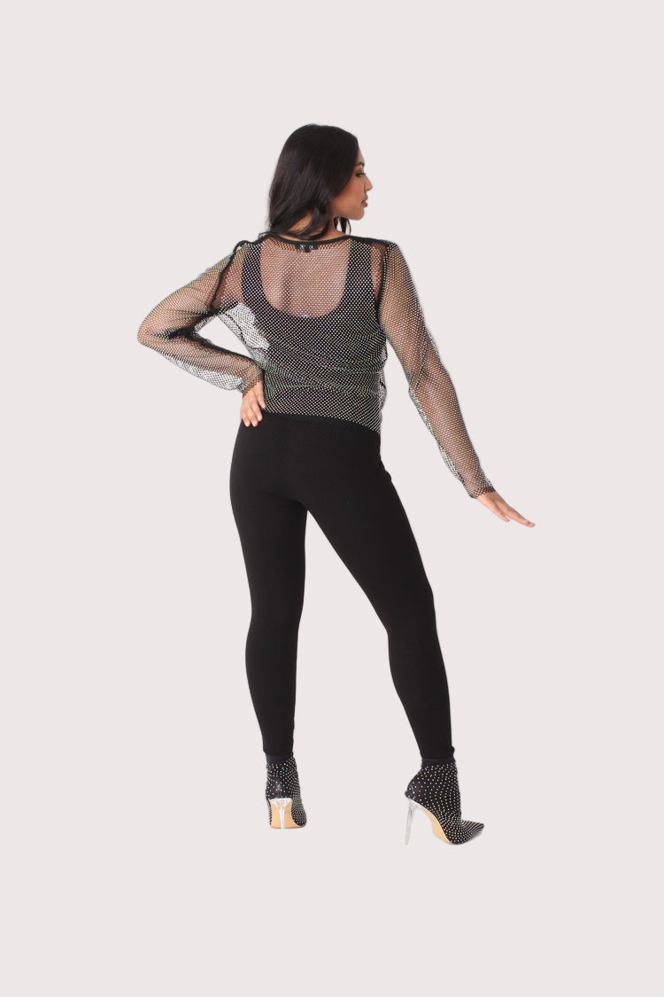 Crystal mesh long sleeve top style 82249 in black shown from the back in a standing pose highlighting the sheer mesh fabric and rhinestone detailing by For Her NYC