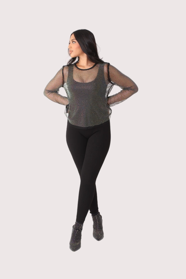 Crystal mesh long sleeve top style 82249 in black shown in a three-quarter standing pose emphasizing the sheer mesh texture and modern styling by For Her NYC