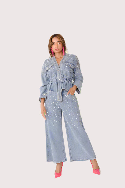 Pearl Cascade peplum denim jacket style 82325 in denim shown in a front standing pose featuring pearl stud embellishments, a gathered waist, and a feminine peplum silhouette by For Her NYC