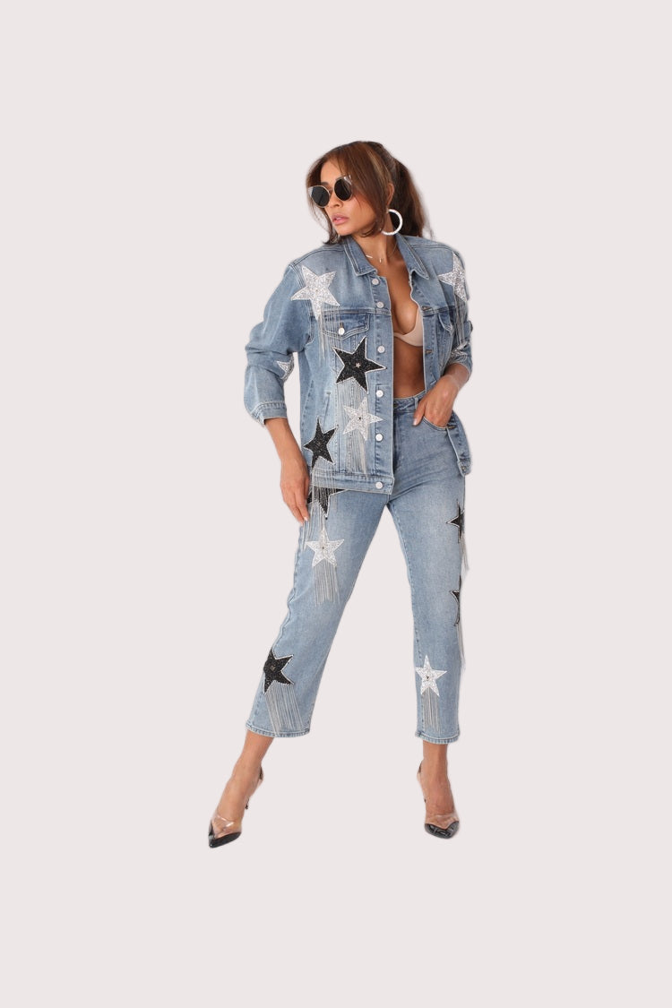 Stardust Dreams denim jacket style 82331 shown from the front in a walking pose emphasizing the celestial star appliqués and statement styling by For Her NYC