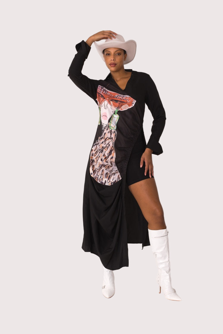 Champagne Dreams maxi dress style 82336 in black multi shown in a fashion pose with hat highlighting the statement graphic print and relaxed maxi fit by For Her NYC