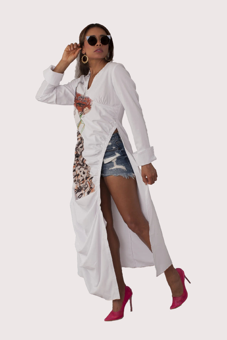 Champagne Dreams maxi dress style 82336 in white multi shown from the front in a layered styling pose showcasing the bold graphic artwork and flowing design by For Her NYC