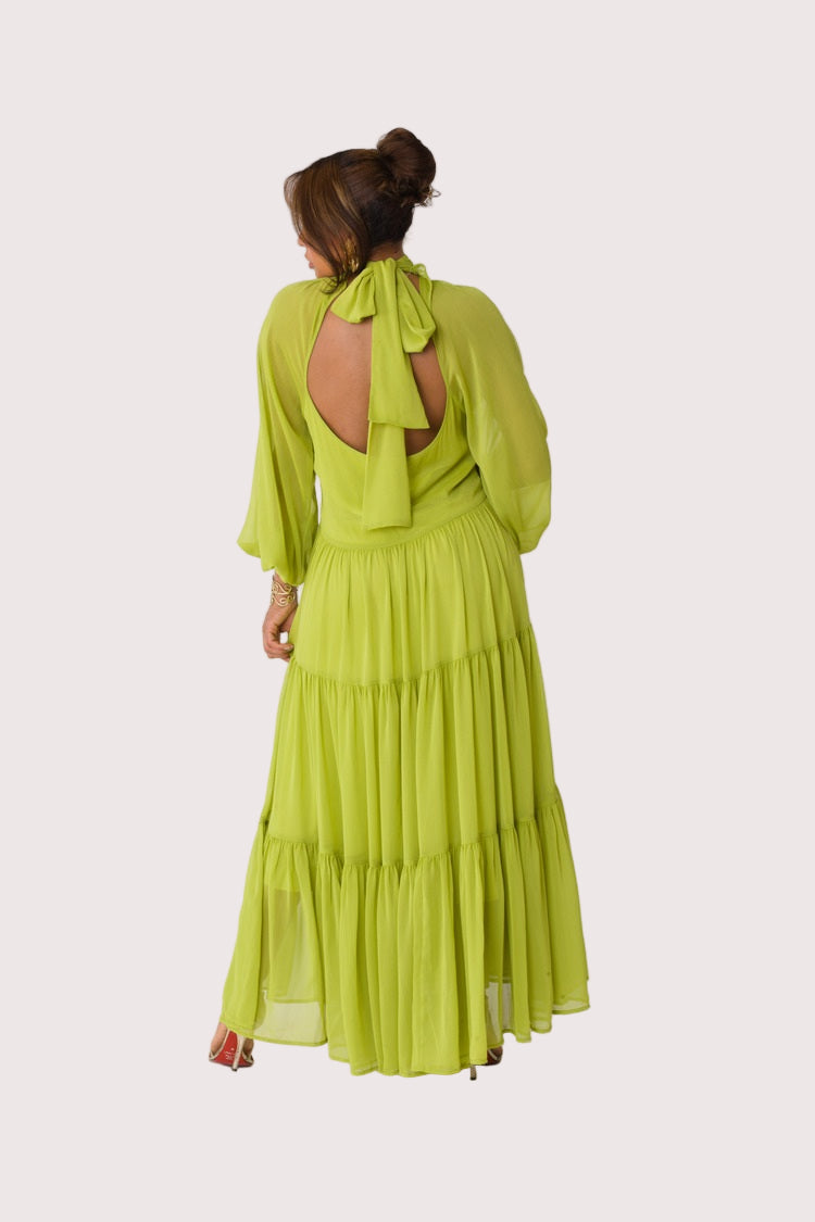 Chartreuse Dream tiered maxi dress style 82348 in lemon grass shown from the back in a standing pose showcasing the relaxed fit and cascading tiers by For Her NYC