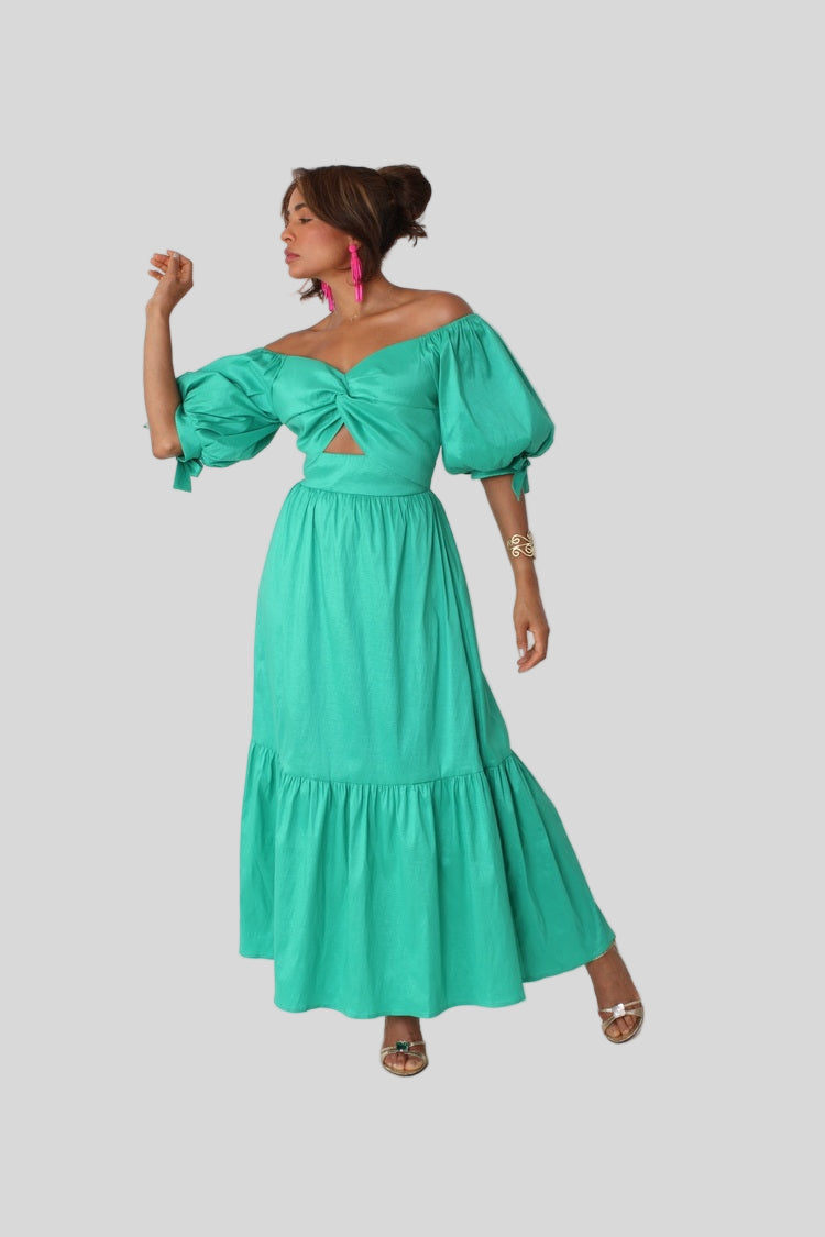 Sage Garden Party maxi dress style 82358 in emerald shown with arm raised in a playful pose highlighting the cutout detail and relaxed movement by For Her NYC