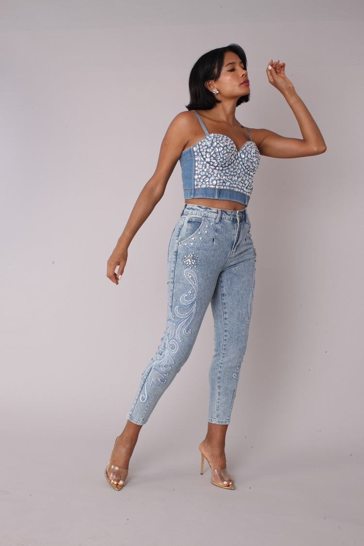Model wearing embroidered capri denim jeans with crystal embellishments, fashion pose with hand on head, For Her NYC