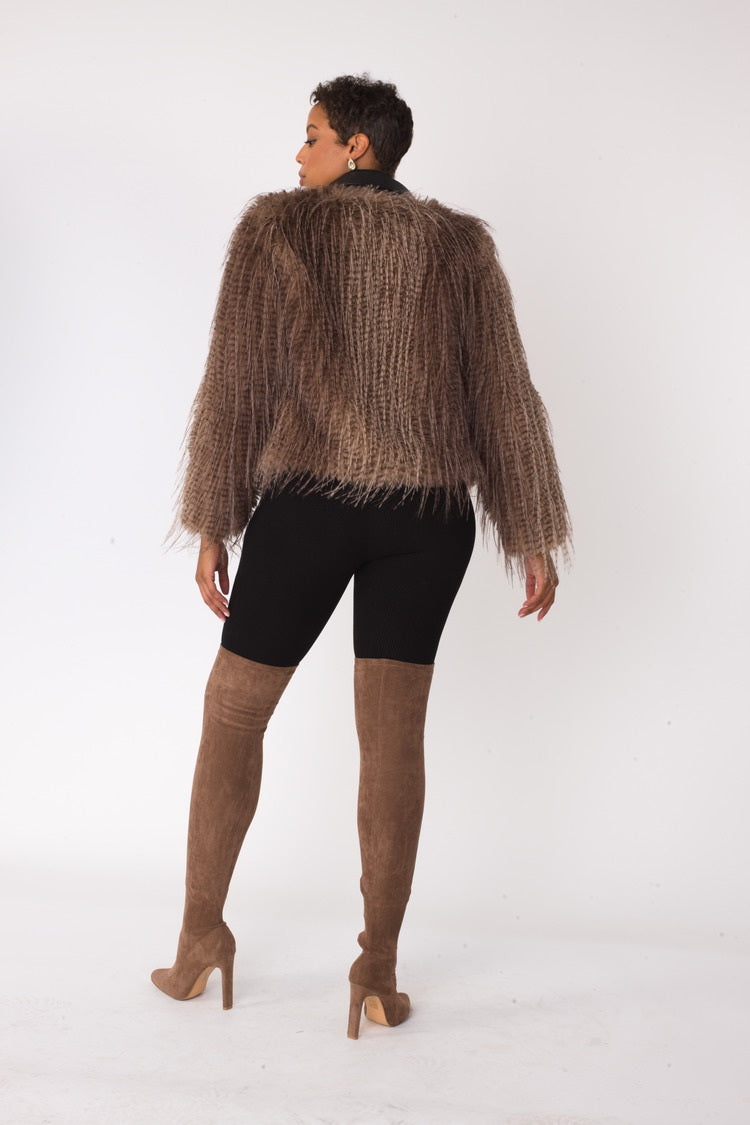 Beige and black shaggy faux fur bomber jacket shown in back view displaying full texture and cropped bomber length by For Her NYC