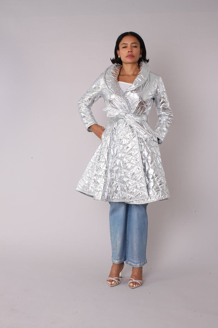 Silver metallic quilted wrap coat shown in front standing pose with tied waist and flared silhouette by For Her NYC