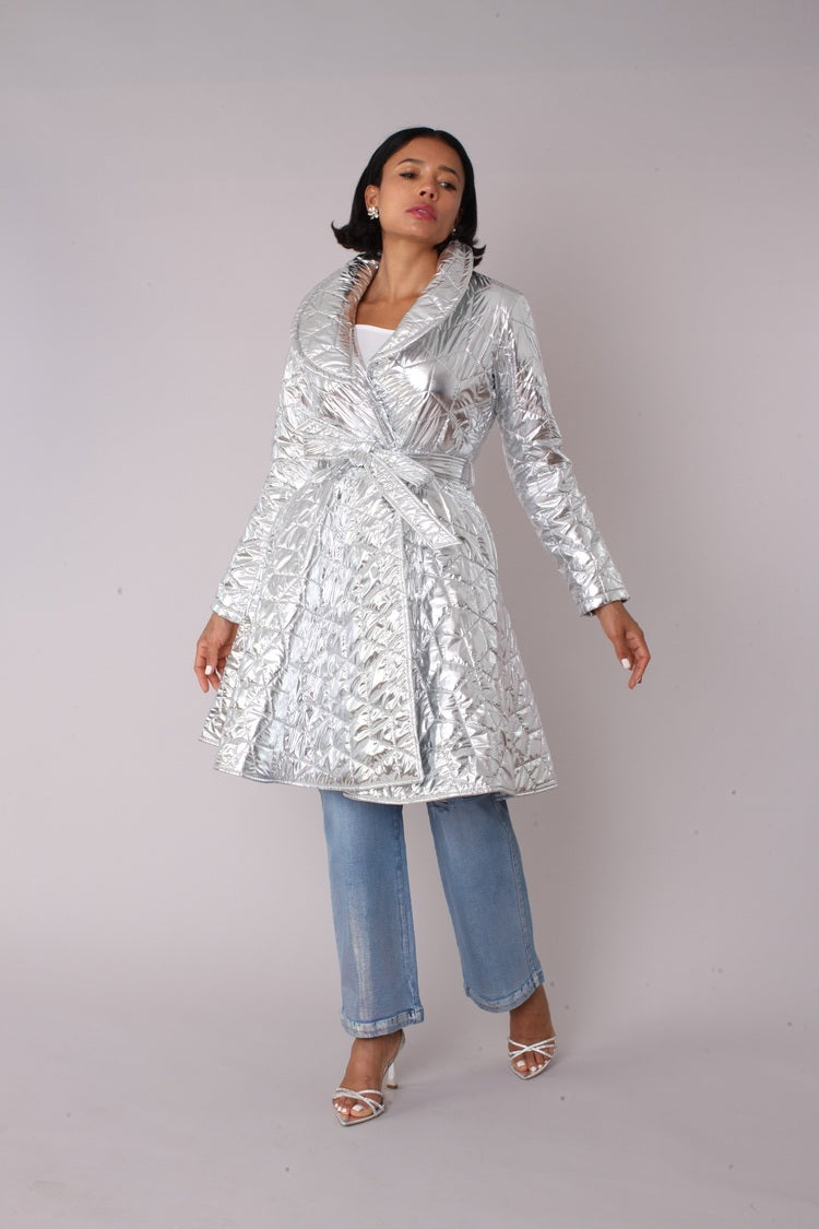Silver metallic quilted wrap coat shown in front walking pose highlighting movement and wrap styling by For Her NYC