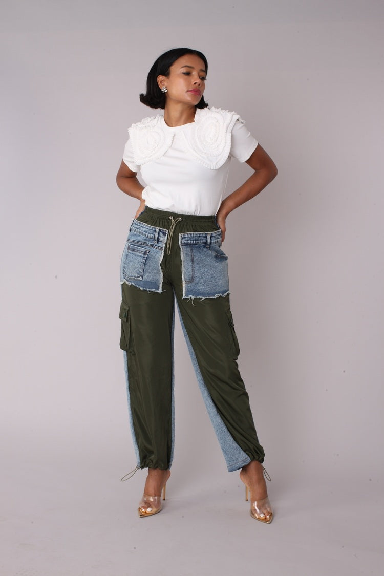 Olive denim hybrid cargo joggers shown in front pose with hand on hip emphasizing streetwear silhouette by For Her NYC