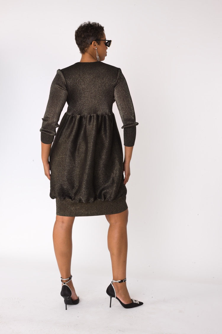 Metallic bubble hem sweater dress in black gold shown from back view by For Her NYC