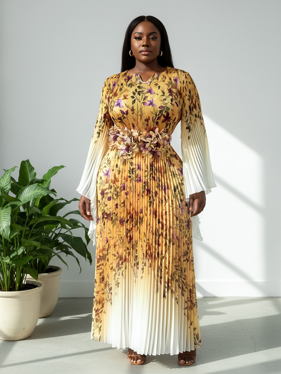 Yellow multi floral pleated maxi dress with statement waist detail and sheer sleeves modeled in soft natural window light For Her NYC