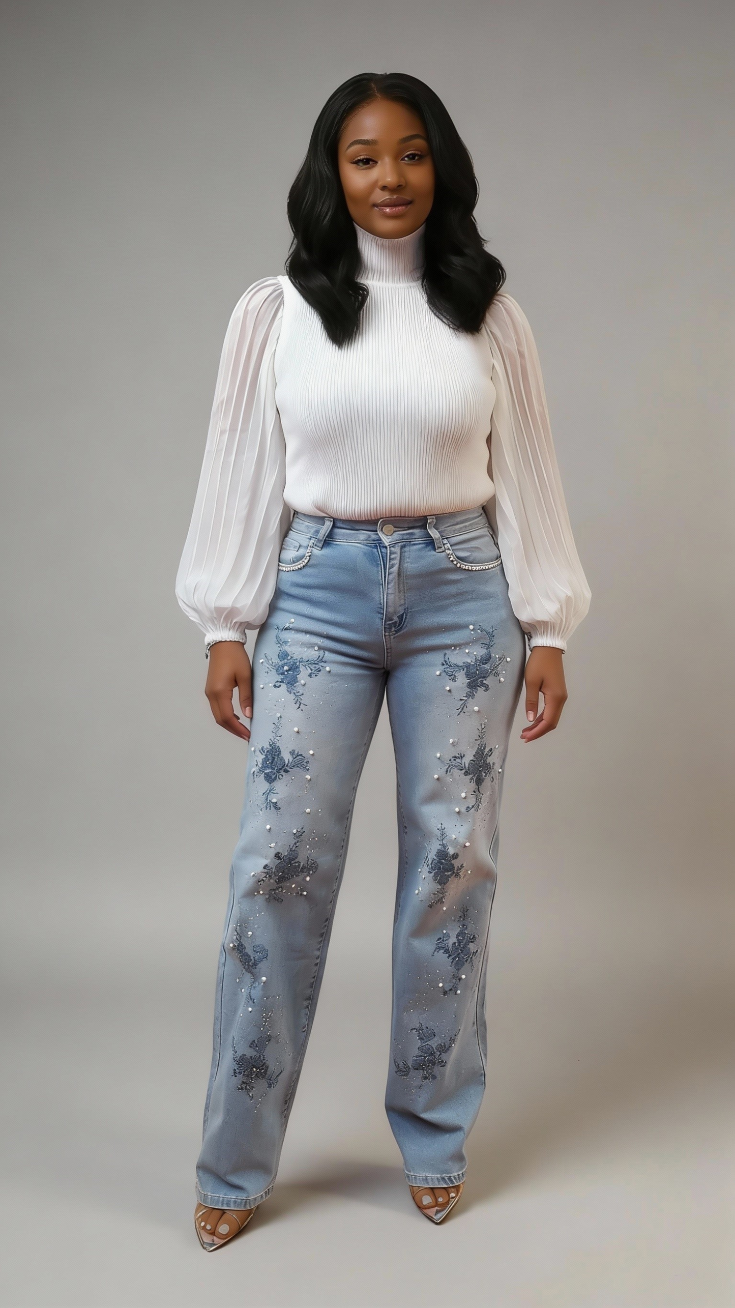 Light wash denim straight-leg jeans with pearl and floral embroidery embellishments, model standing facing forward styled with white blouse For Her NYC