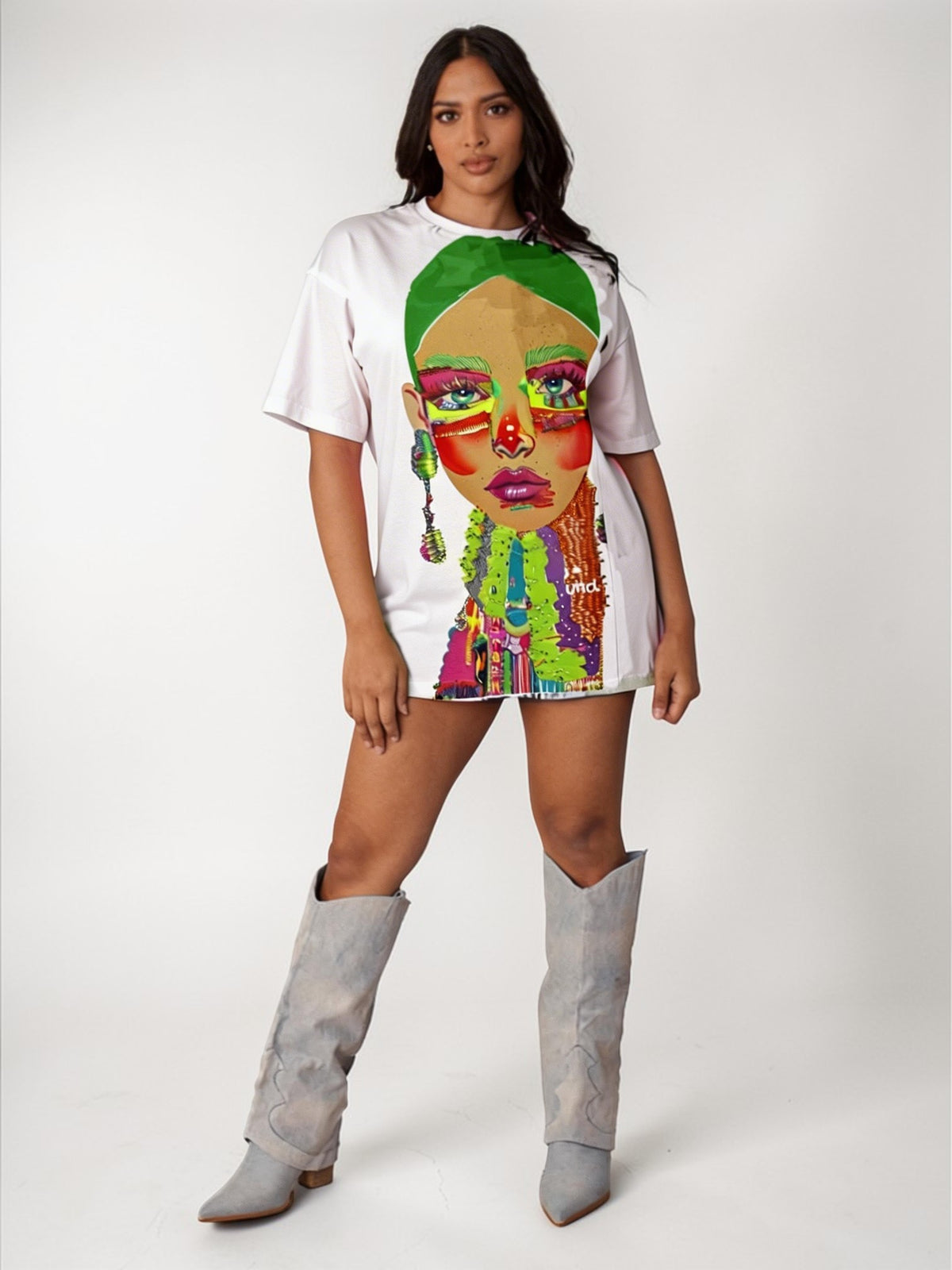 White/Multi graphic tee featuring vibrant electric portrait artwork with rhinestone detailing, model standing front view wearing tall boots For Her NYC