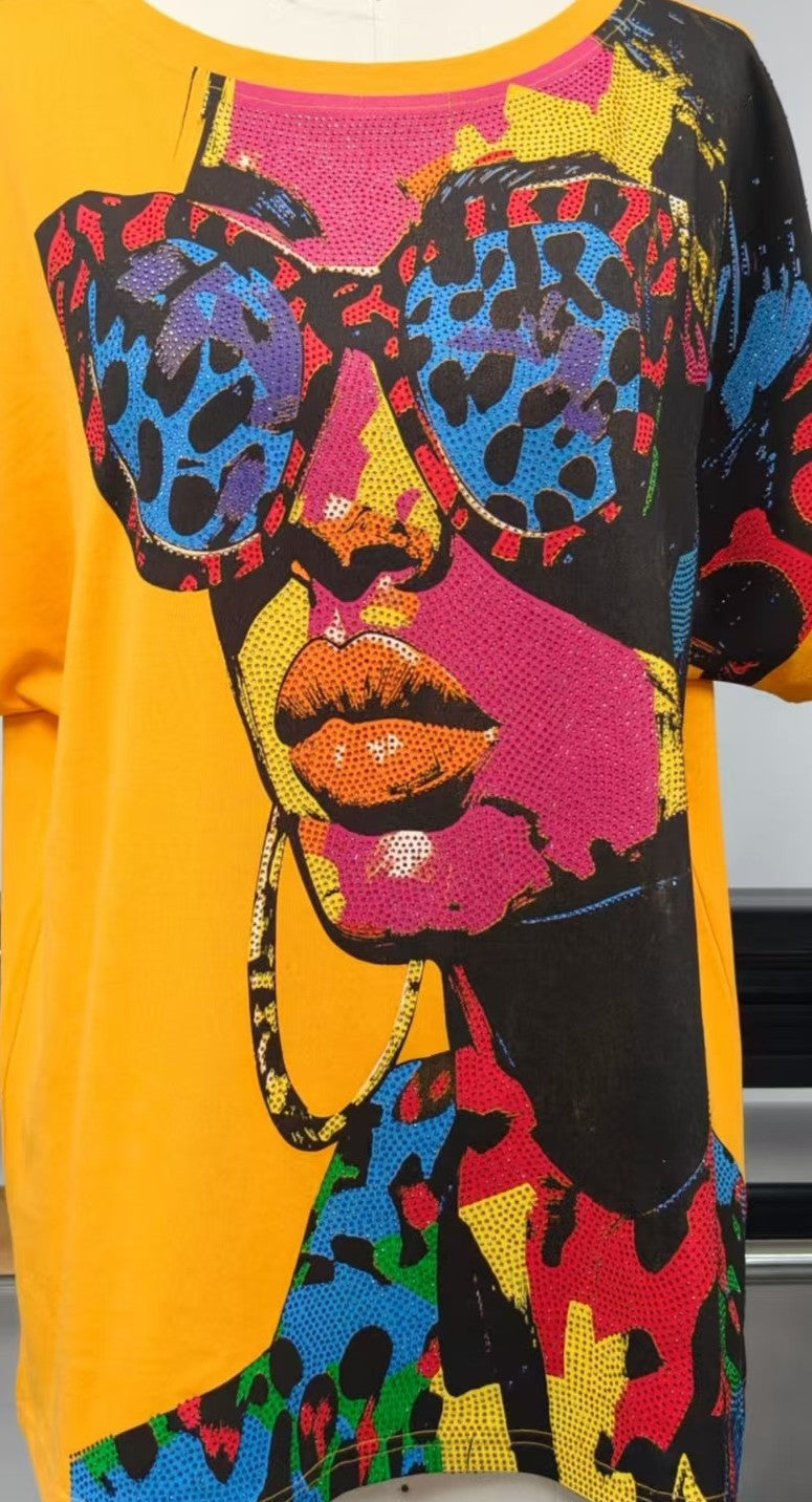 Close-up detail of a colorful artistic face graphic with embellished sunglasses on an oversized fashion tee – For Her NYC