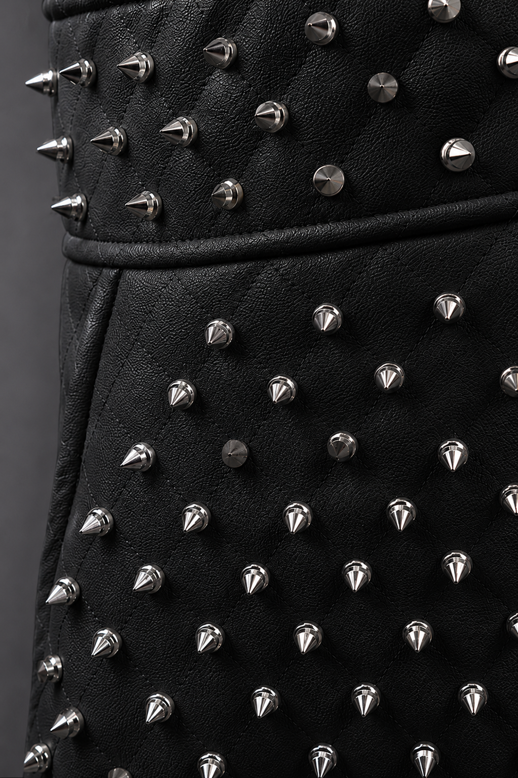 Model wearing pleather quilted flared skirt with studs in black, front-facing hero pose highlighting flared silhouette, quilted texture, and statement stud detailing by For Her NYC