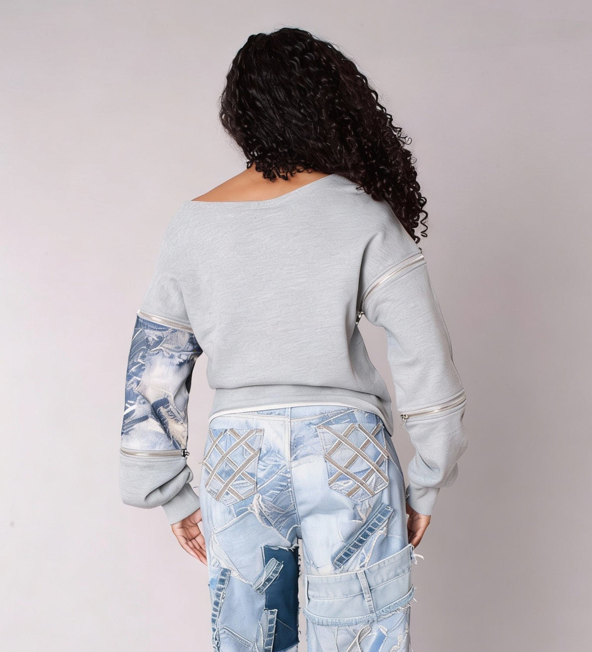 Back view of a grey off-shoulder sweatshirt featuring denim patchwork accents, styled with matching denim bottoms — For Her NYC