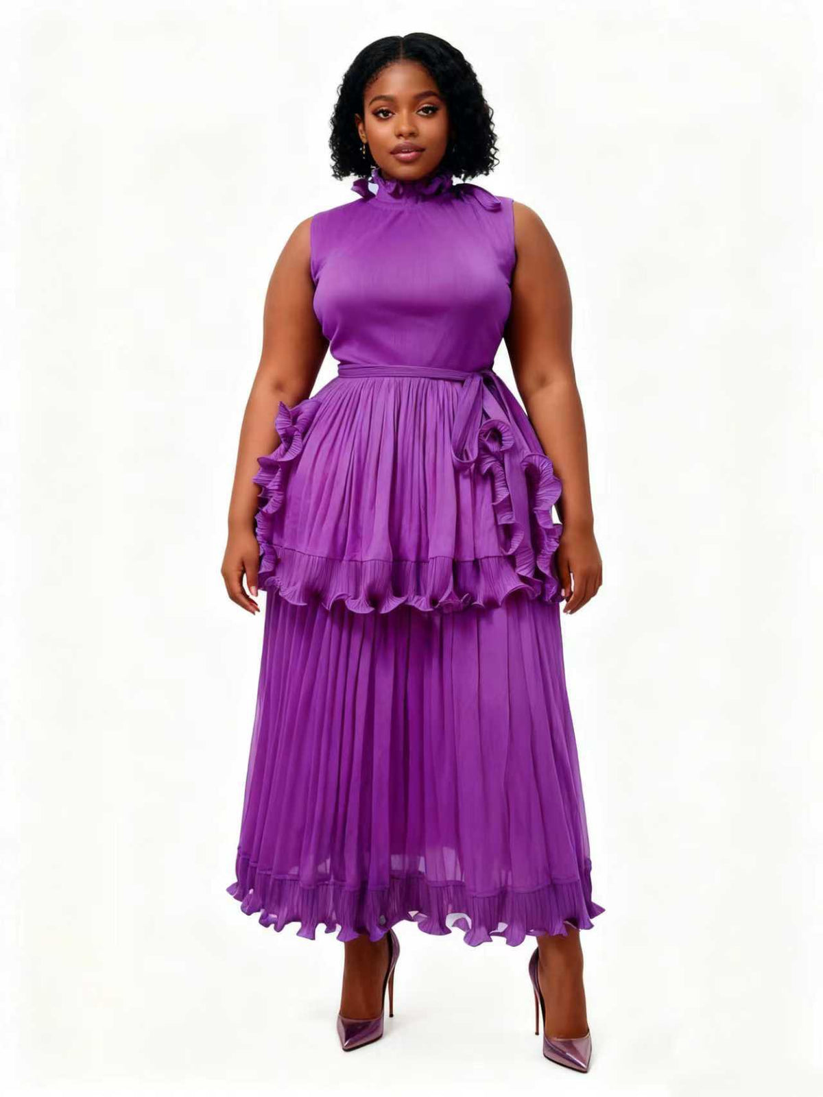 Woman wearing a purple ruffle tiered pleated midi dress with a gathered neckline and defined waist tie, styled with heels — For Her NYC