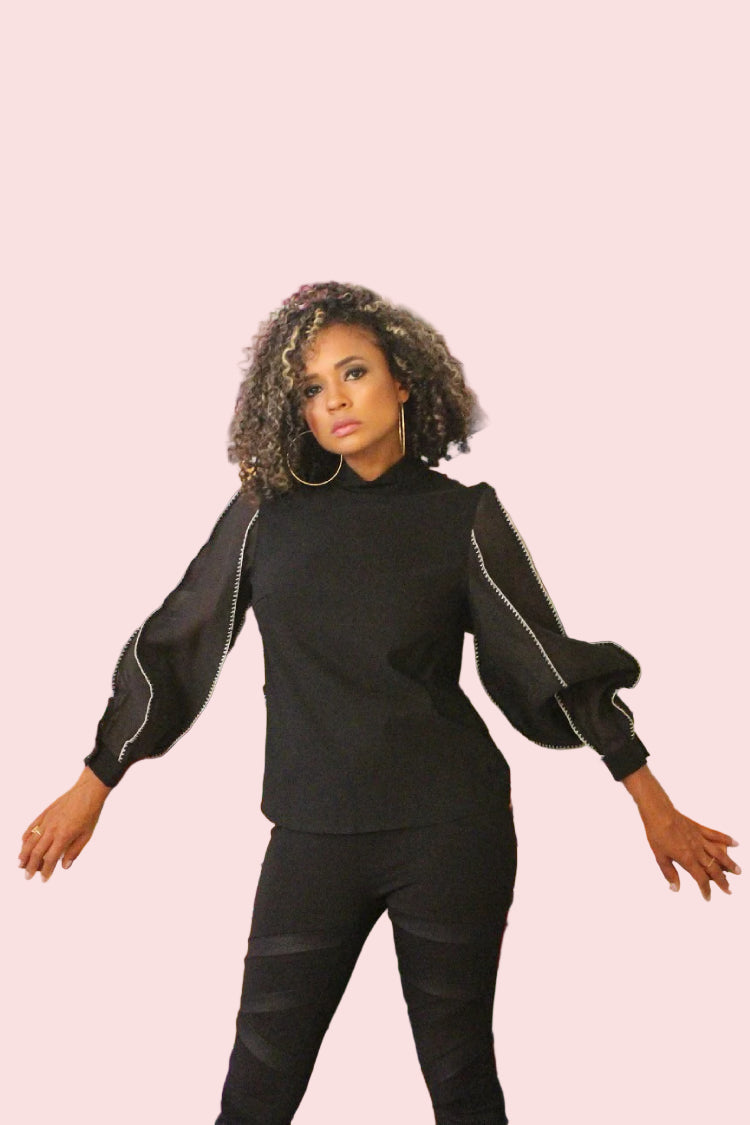 Black elegant puff sleeve blouse with sheer sleeves and white contrast stitching trim, high neckline, and polished feminine silhouette perfect for chic workwear or special occasions.