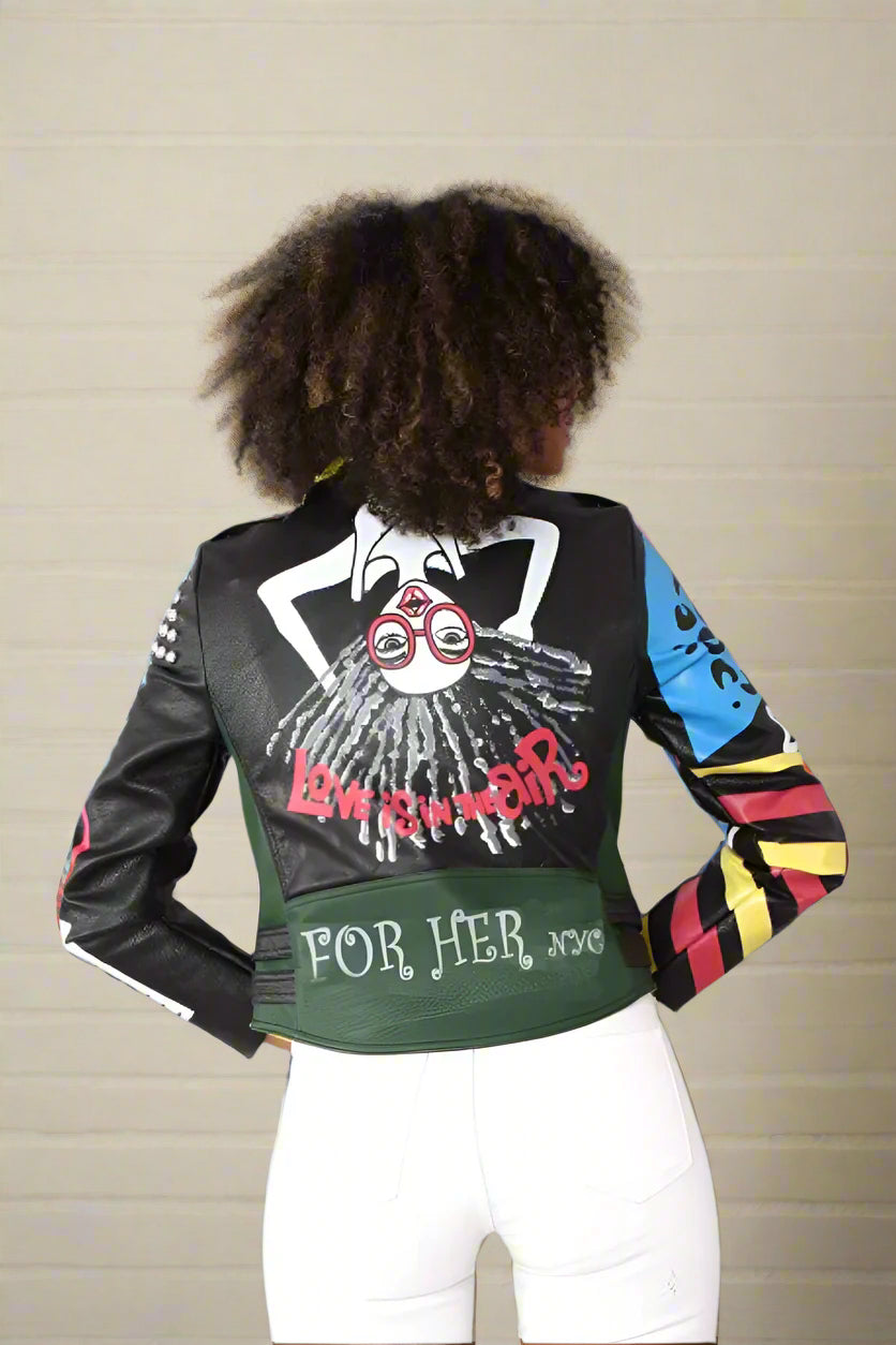 Back view of bold graphic faux leather moto jacket showing colorful graffiti artwork and edgy streetwear detail.