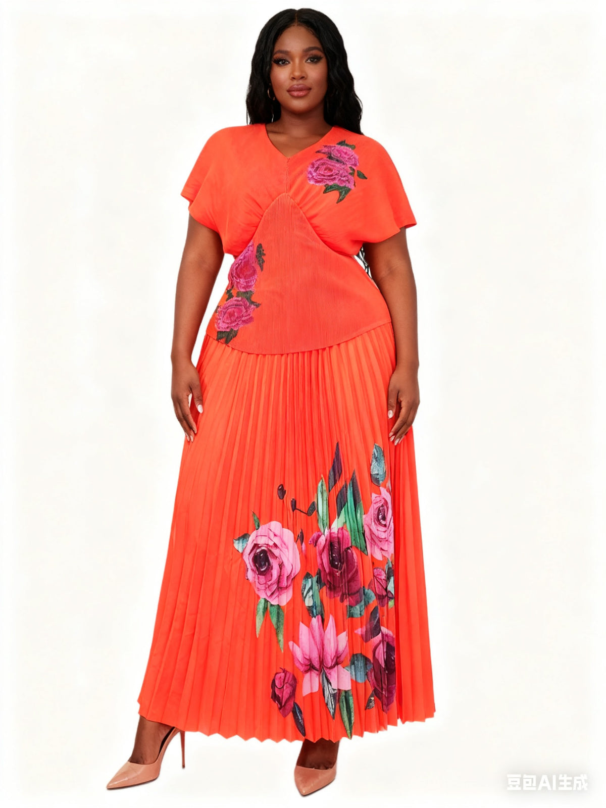 Front view of model wearing an orange pleated skirt set with bold floral detailing and relaxed fit top, For Her NYC