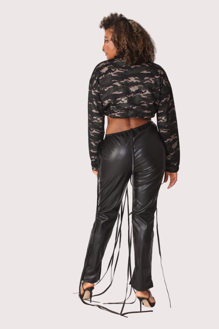 Model wearing camouflage mesh cropped jacket, front standing pose showcasing relaxed silhouette, zip-up closure, and layered streetwear look by For Her NYC