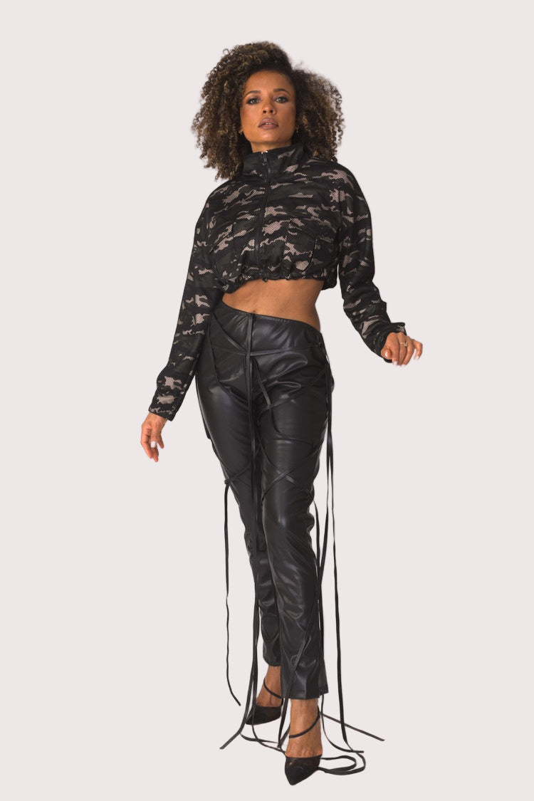 Model wearing camouflage mesh cropped jacket, forward step pose highlighting sheer texture, modern camo pattern, and fashion-forward street style by For Her NYC