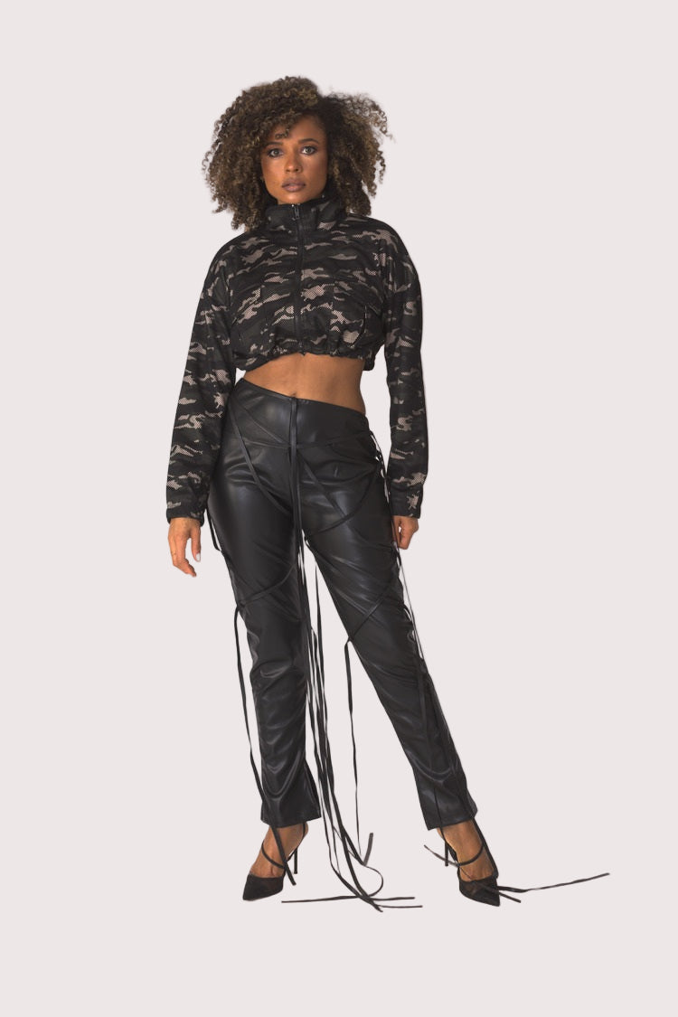 Model wearing camouflage mesh cropped jacket, front walking pose emphasizing lightweight mesh movement, cropped fit, and edgy urban styling by For Her NYC