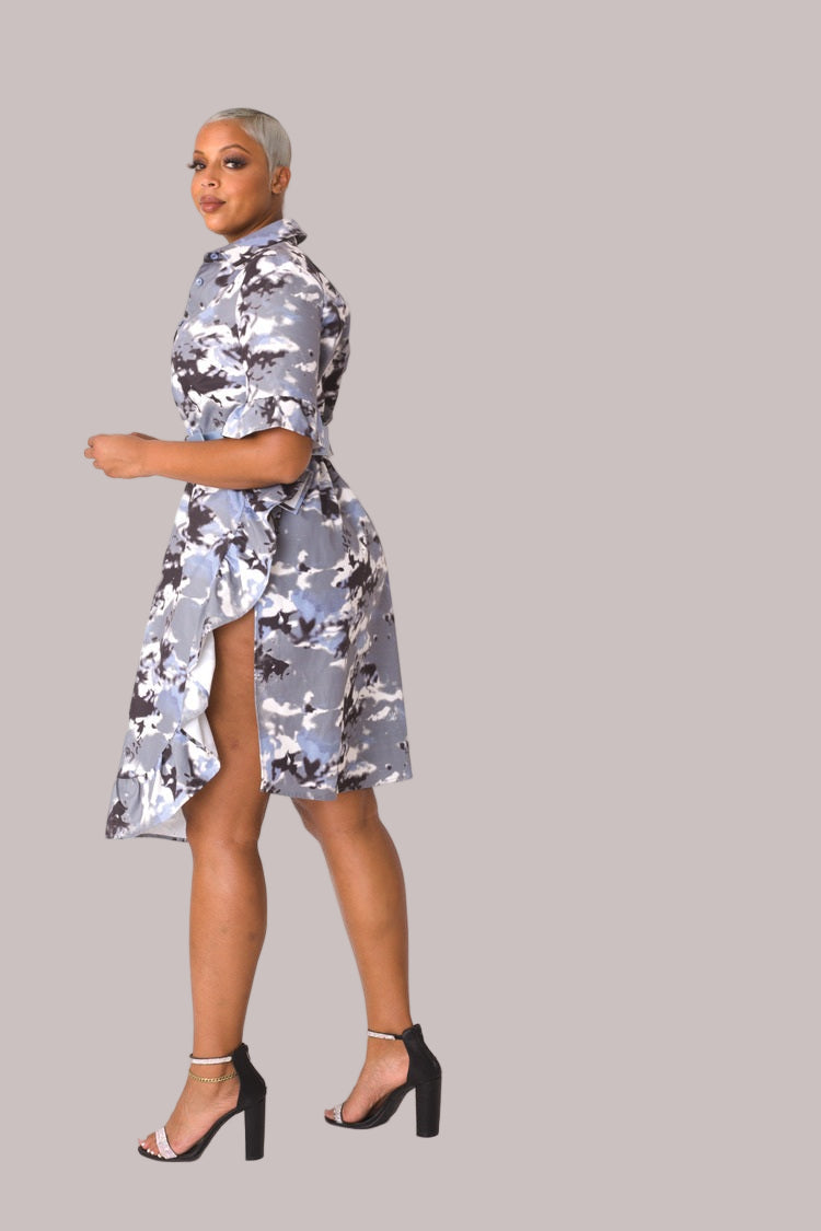 Model wearing camo print ruffle midi dress, angled front pose highlighting layered ruffle detail, feminine silhouette, and modern camo design by For Her NYC