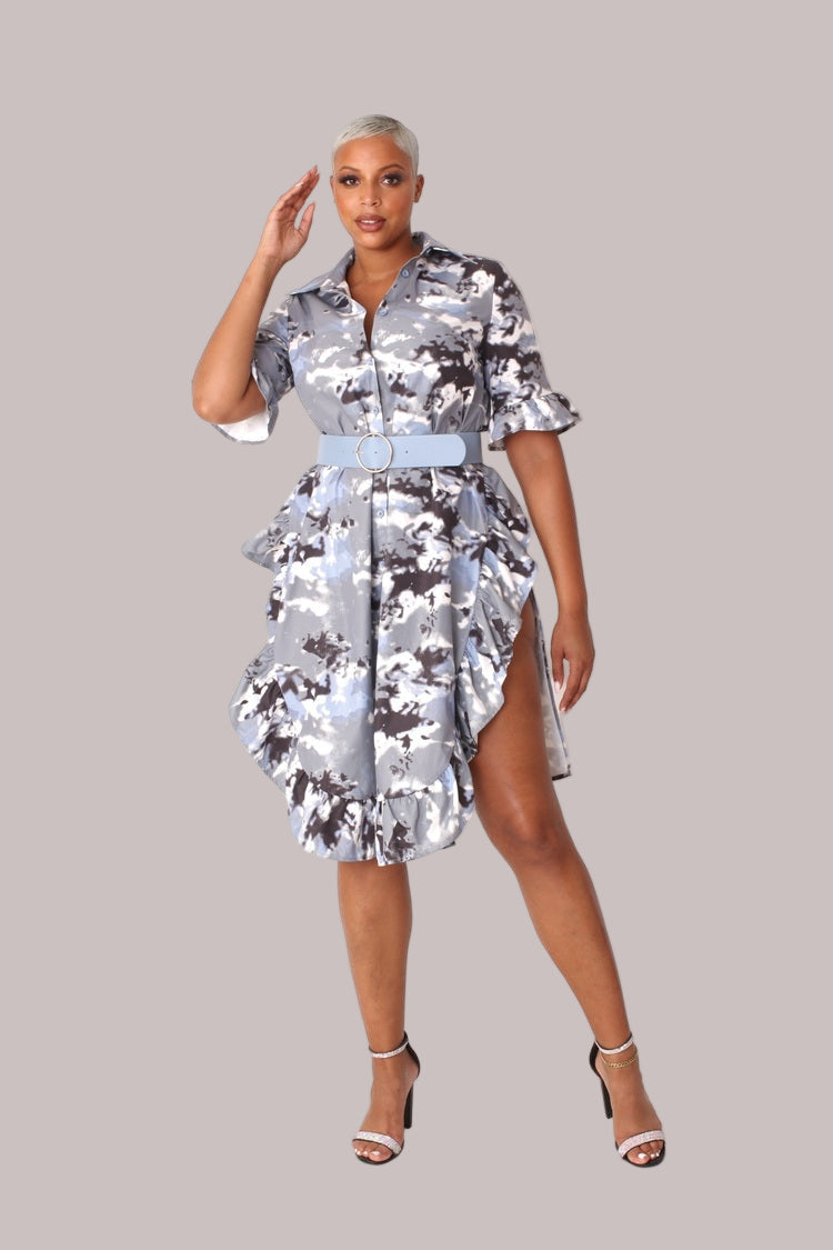 Model wearing camo print ruffle midi dress, front walking pose showcasing movement of the ruffle hem, fluid silhouette, and camo pattern by For Her NYC