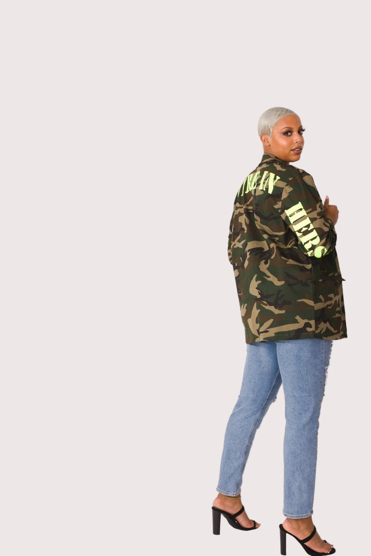 Model wearing camouflage utility jacket, front walking pose showcasing relaxed movement, streetwear styling, and functional utility design by For Her NYC