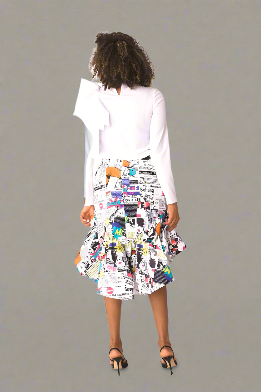 Model wearing comic print ruffle midi skirt, full back view showcasing print placement and flowing silhouette by For Her NYC